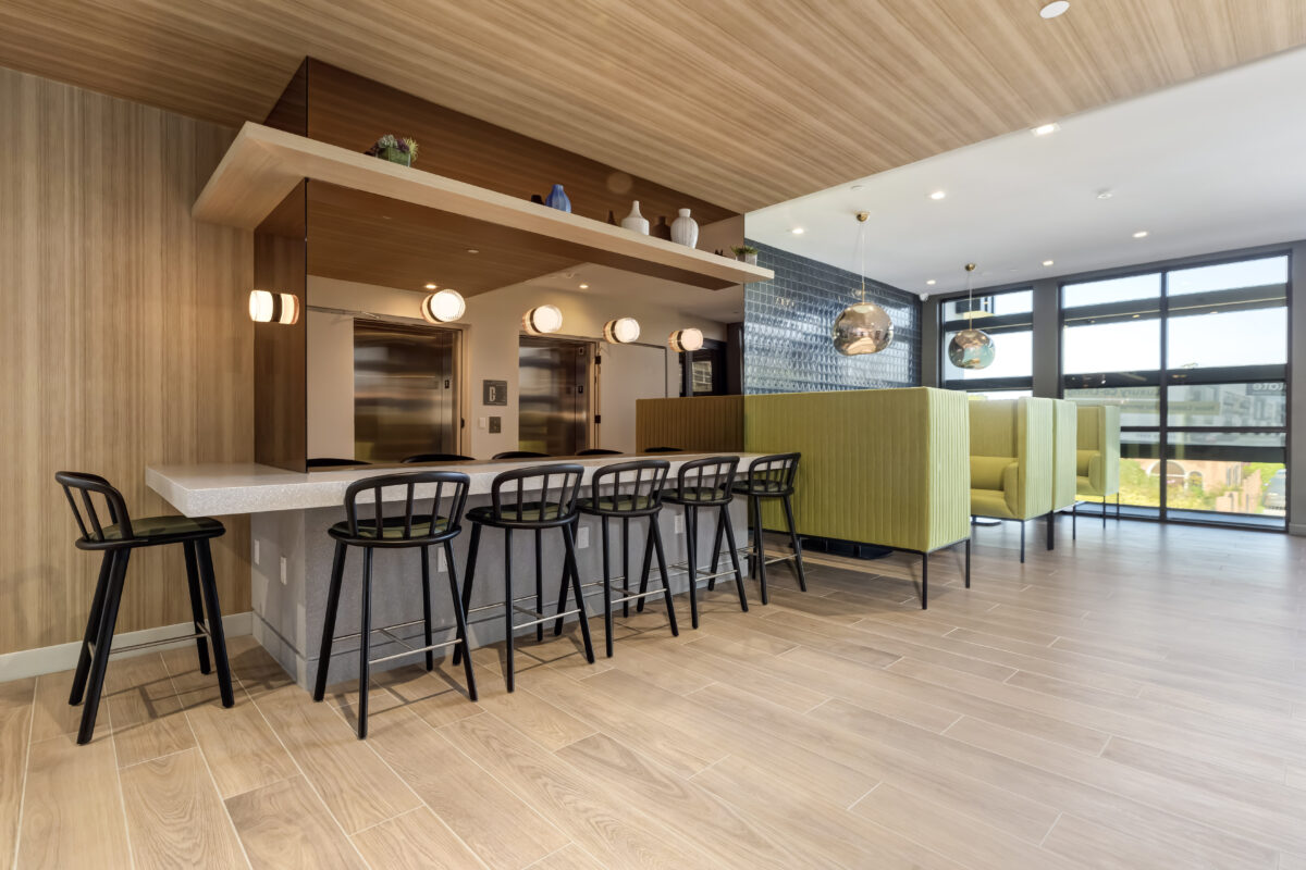 extended view of co-working area with private pod and bar stoolss