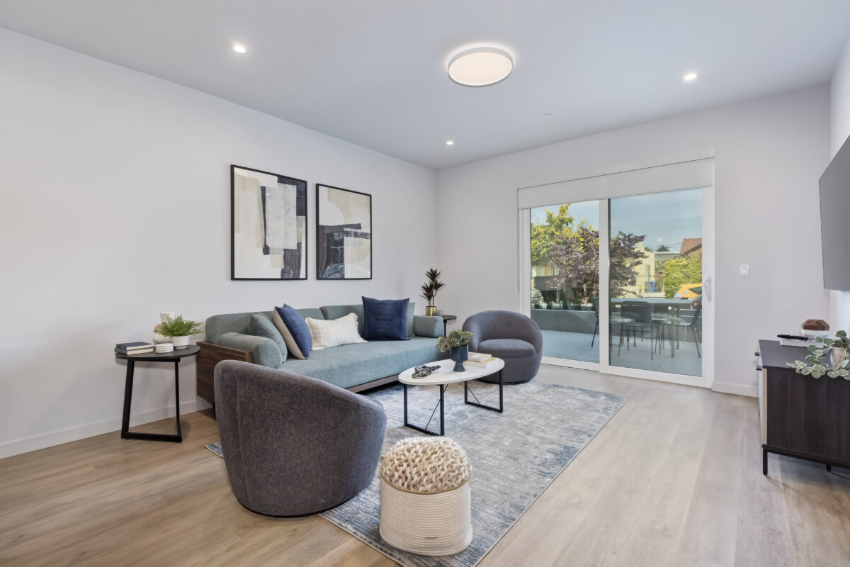 Open concept living room and kitchen with glass patio doors