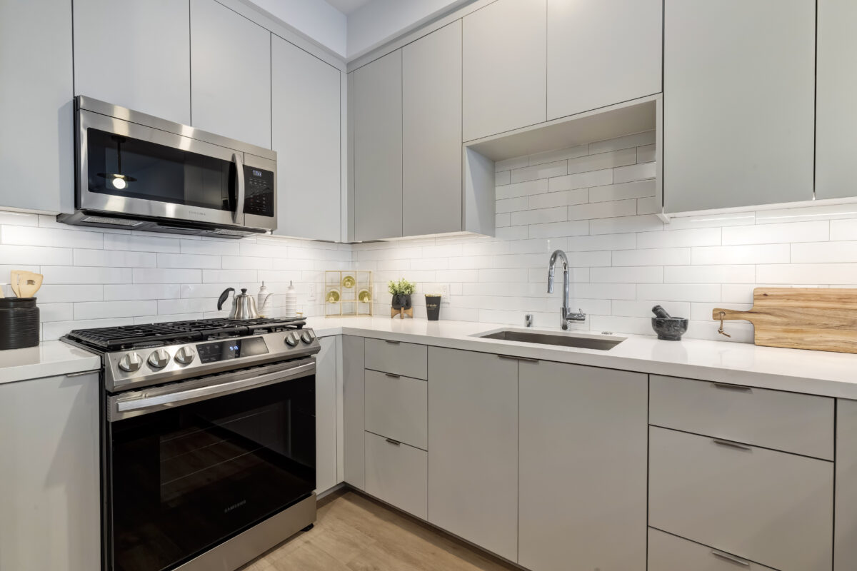 modern kitchen with white cabinets and appliances