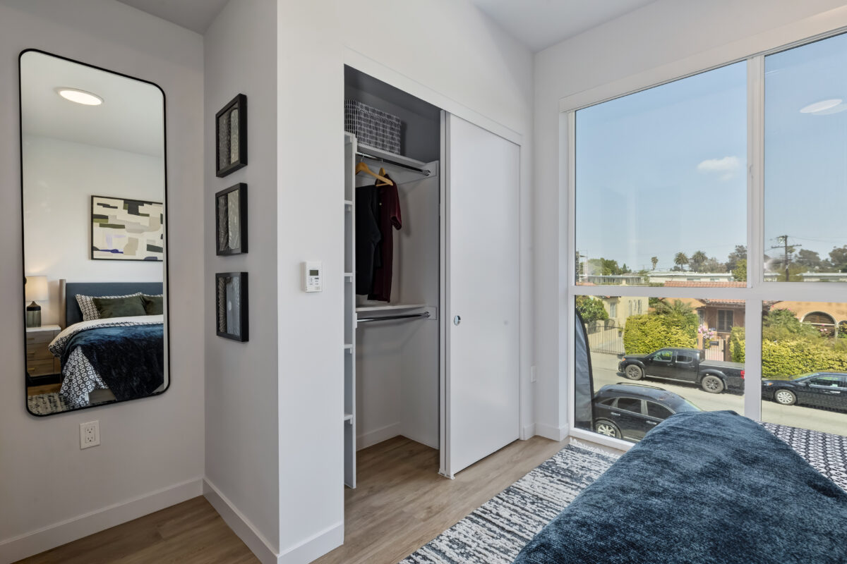 bedroom with modern decor and large glass windows